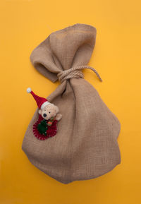 Close-up of stuffed toy against yellow background