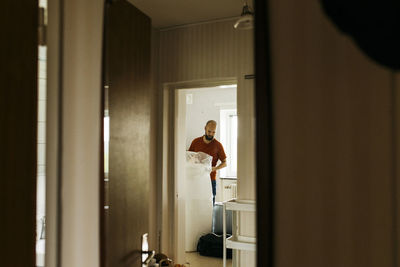 Man covering mattress in foil