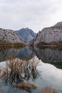 Scenic view of lake and mountains against sky