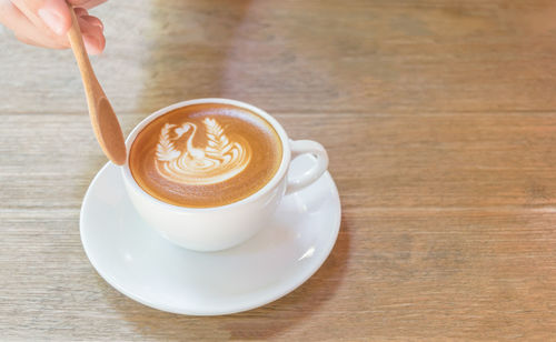 Close-up of cappuccino served on table