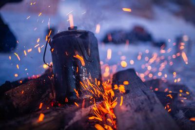 Close-up of fire on log at night