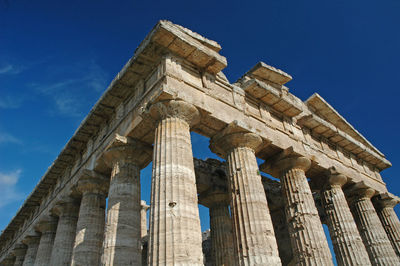 Low angle view of historical building against blue sky