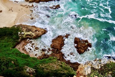 High angle view of rocks on beach - from east head view point over the rocky knysna coastline