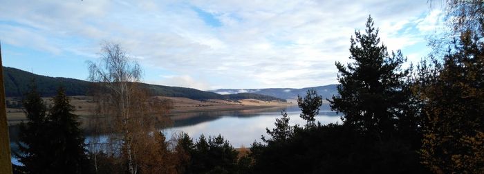 Scenic view of lake and mountains against sky