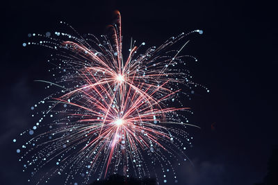 Low angle view of firework display at night