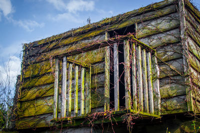 Low angle view of abandoned house against sky