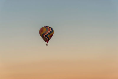 Low angle view of hot air balloons against sky during sunset