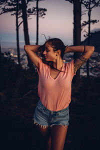 Young woman wearing hat while standing on land
