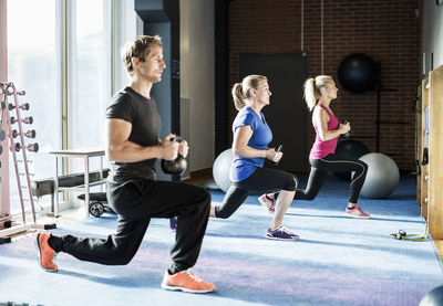 Customers exercising with kettlebells at gym