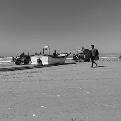 Rear view of man standing on boat in sea