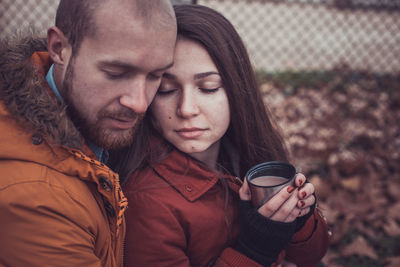 Young couple in drinking glass outdoors