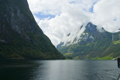 Scenic view of lake and mountains against sky