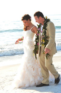 Young couple kissing on beach during sunset