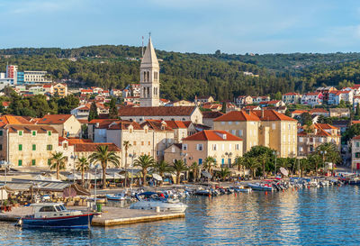 View of townscape by sea against sky