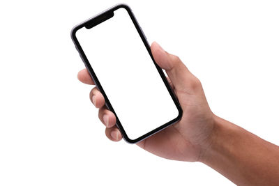 Low angle view of hand holding smart phone over white background