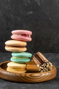 Macaroons stacked on a dark background. delicious french cuisine dessert creatively decorated