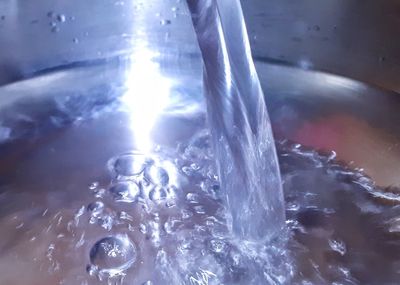 Close-up of water splashing in glass