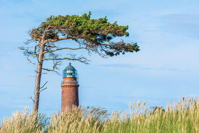 Low angle view of lighthouse against blue sky