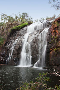 Low angle view of waterfall against sky