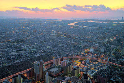 High angle view of city and buildings against sky during sunset