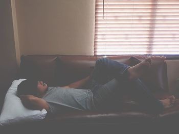 Man sleeping on sofa at home