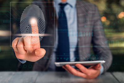 Midsection of man using mobile phone