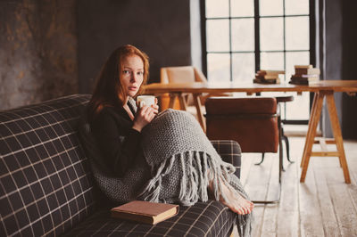 Portrait of woman sitting on chair