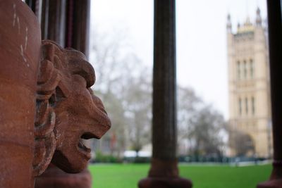 Close-up of lion statue against building