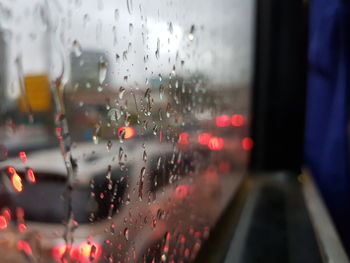 Close-up of wet glass window in rainy season