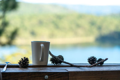 Close-up of coffee cup on table against sky