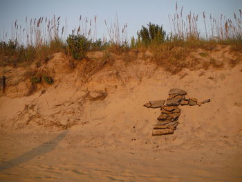 Text on sand at beach against sky