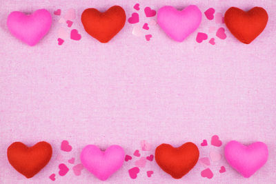 Heart shape with pink petals on background