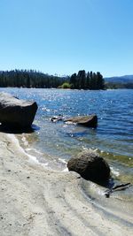 Scenic view of lake against clear blue sky