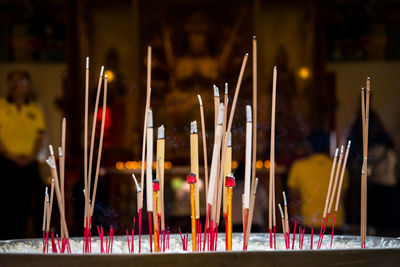 Close-up of lit candles in temple