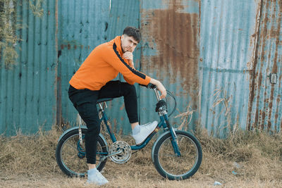 Young man riding vintage bicycle
