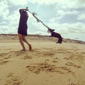 Full length of woman standing against sky