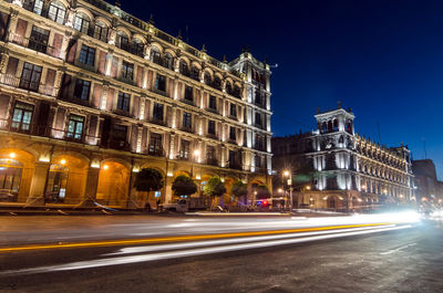 Light trails on road at zocalo in city during night