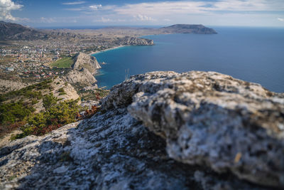 High angle view of rocks and sea against sky