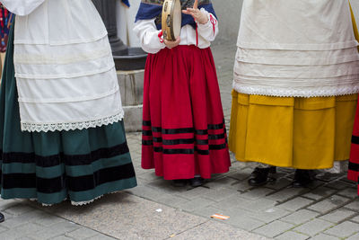 Low section of people standing on street