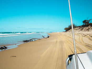 Panoramic view of beach against clear blue sky