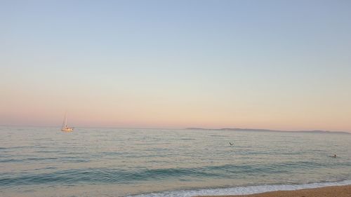 Scenic view of sea against clear sky during sunset