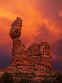 Balanced rock in sunset with dramatic clouds in arches national park, utah, usa