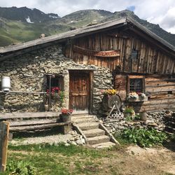 Exterior of old house by building against sky