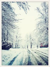 Road passing through snow covered landscape