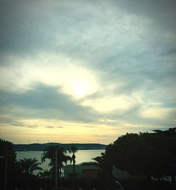 Scenic shot of calm lake against cloudy sky