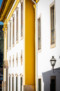 Low angle view of street light by building