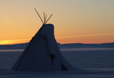 Close-up of sea against sky at sunset
