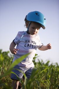 Portrait of boy standing on field