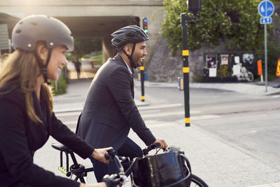 Man riding bicycle on street in city