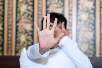 Man covering face with hands